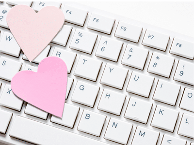 Two pink hearts on top of keyboard