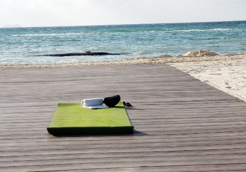 Yoga mat on pier at the beach