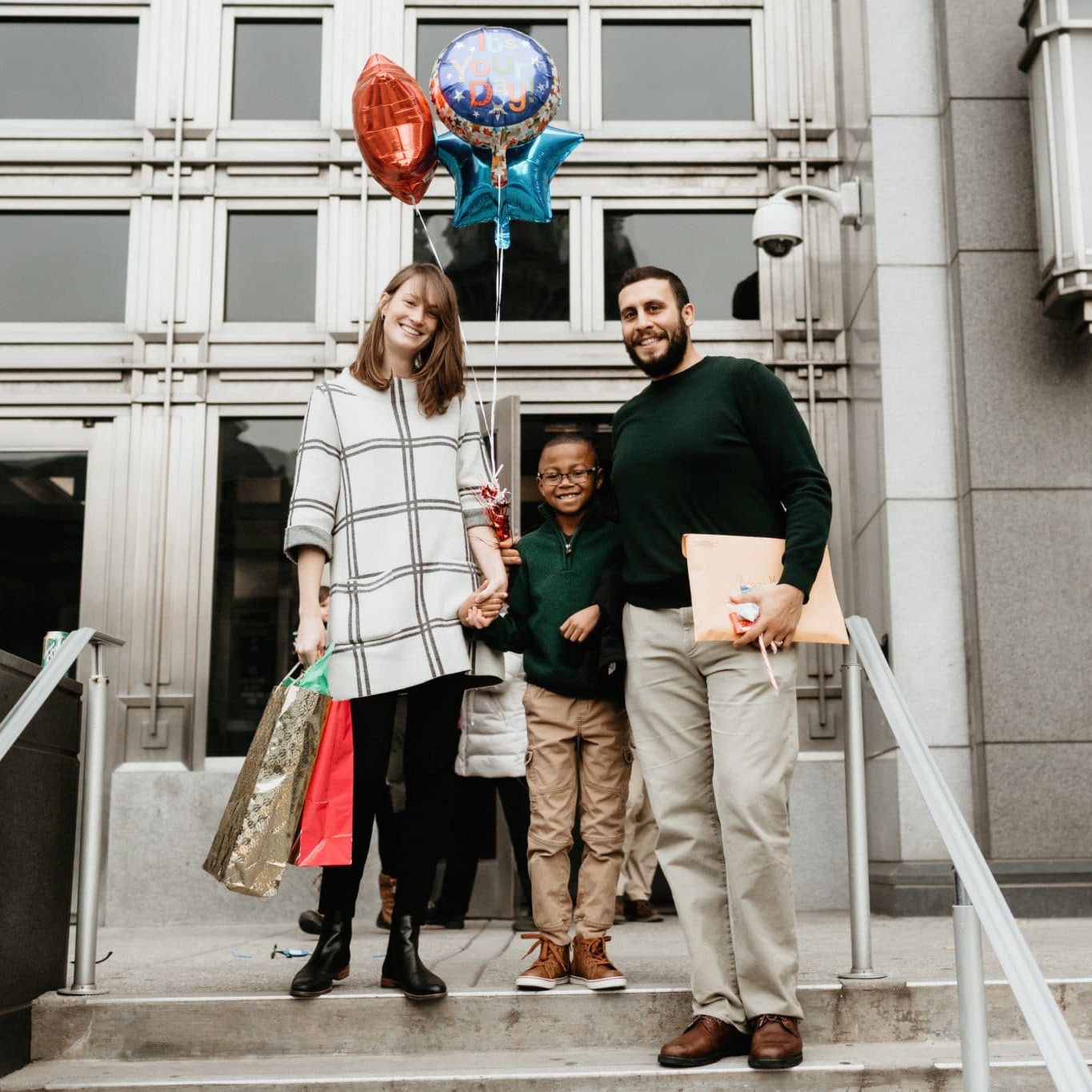 Multi Racial Family Photos With Adoptive Son Photos of adoptive family on adoption day Buffalo New York. Parents are caucasian. Son is African American and 9 years old. Family is joyful.
