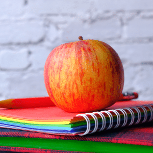 Apple on top of books - back to school